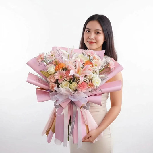 Woman holding a bouquet of flowers with pink ribbons on a white background