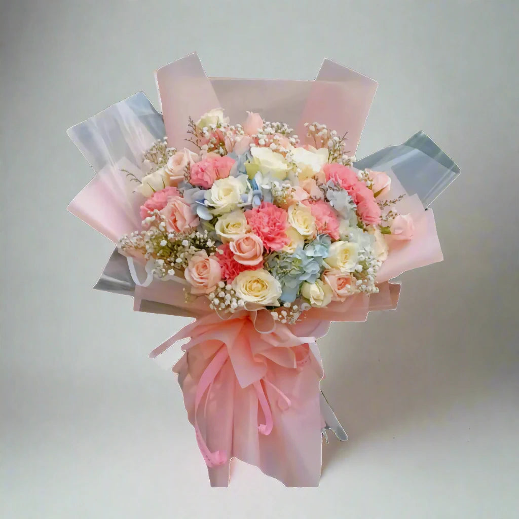 Bouquet of flowers wrapped in pink paper on a light gray background
