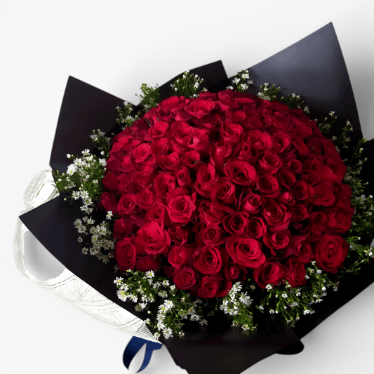 The Flowercart's Meadow Fresh bouquet: 100 crimson roses with baby's breath, perfect for proposals and anniversaries.