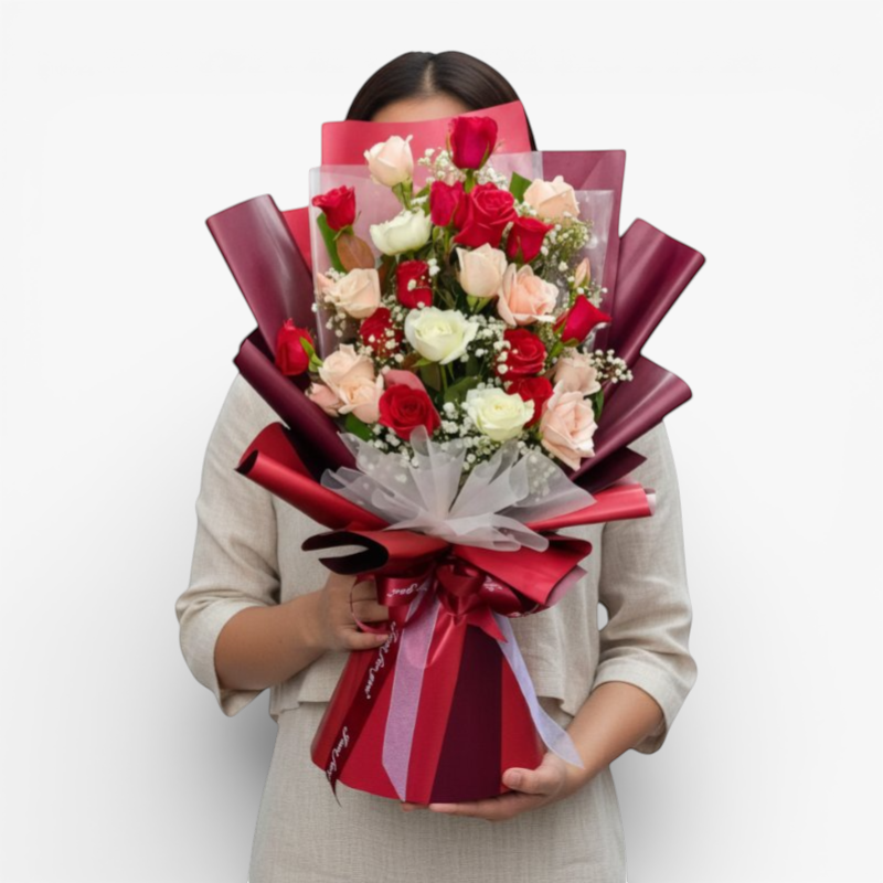 The Flowercart Hermosa bouquet: 24 red, white, and pink roses with baby's breath, elegantly wrapped in burgundy.