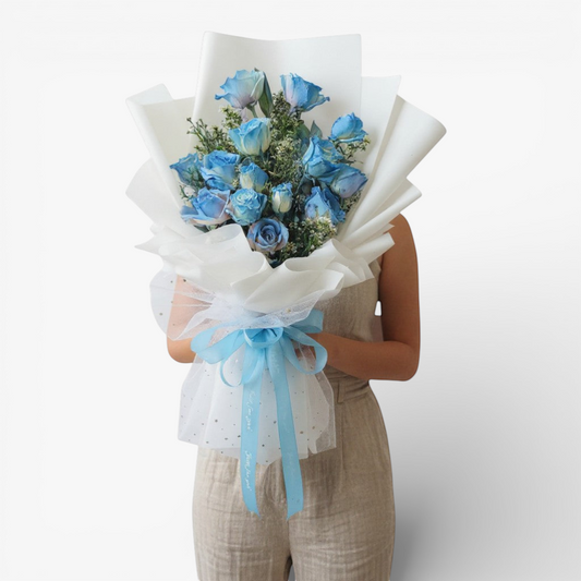 The Flowercart 12 blue roses bouquet with white wrapping and blue ribbon, perfect for unique occasions.
