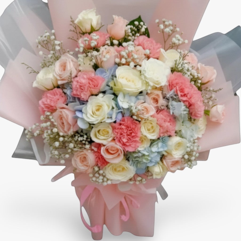The Flowercart Pastel Dreams bouquet: pink roses, white roses, pink carnations, blue hydrangea, and baby's breath.