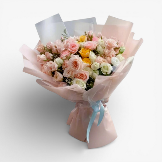 The Flowercart's Fior di Luna bouquet: a mix of pink, white, and yellow roses with baby's breath, elegantly wrapped.
