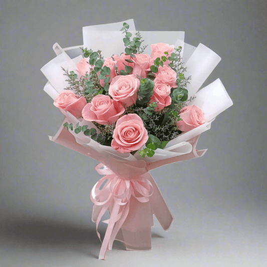 Bouquet of pink roses with greenery on a white background