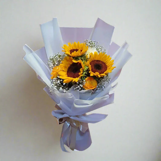 Bouquet of sunflowers wrapped in white paper on a light background
