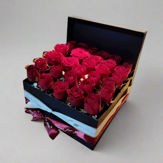 Box of red roses with a decorative ribbon 