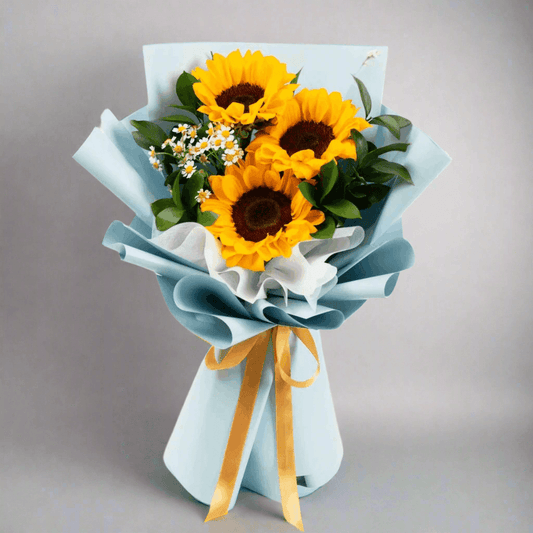 Bouquet of sunflowers wrapped in light blue paper