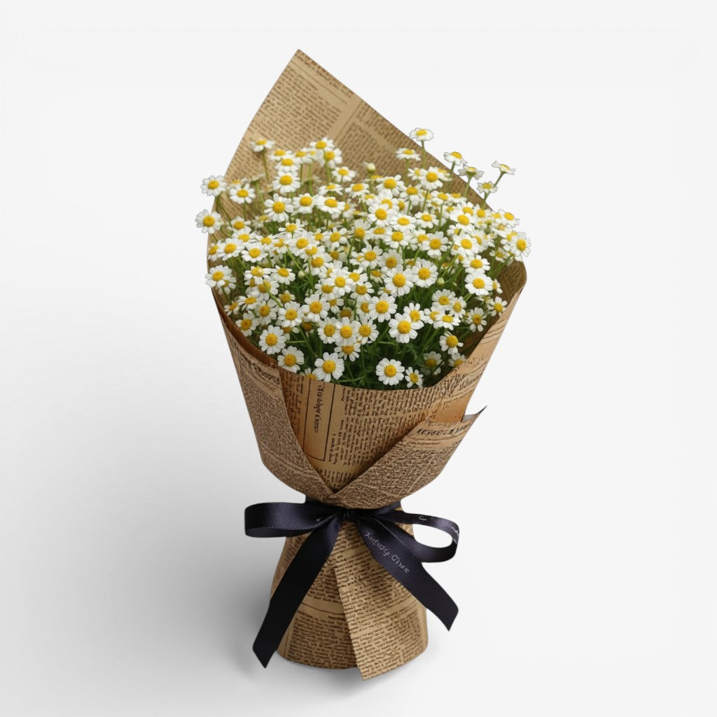 Bouquet of white flowers wrapped in brown paper with a black ribbon on a light gray background