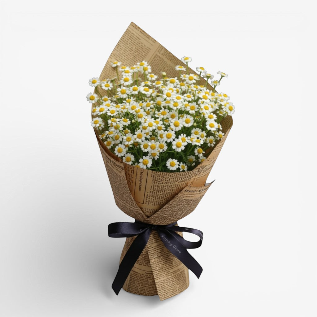 Bouquet of white flowers wrapped in brown paper with a black ribbon on a light gray background