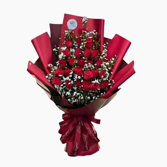 Bouquet of red roses wrapped in red paper on a white background