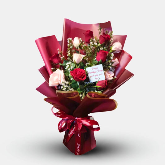 Sweet heart Bouquet of flowers wrapped in red paper with a card on a white background