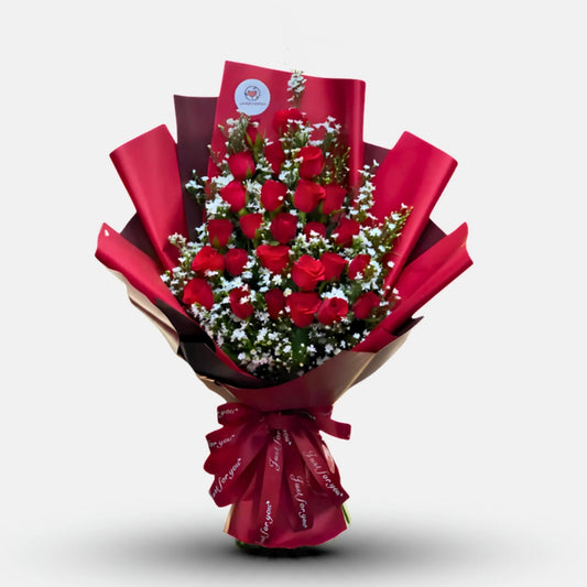 Valley Scent - Bouquet of red roses wrapped in red paper on a white background