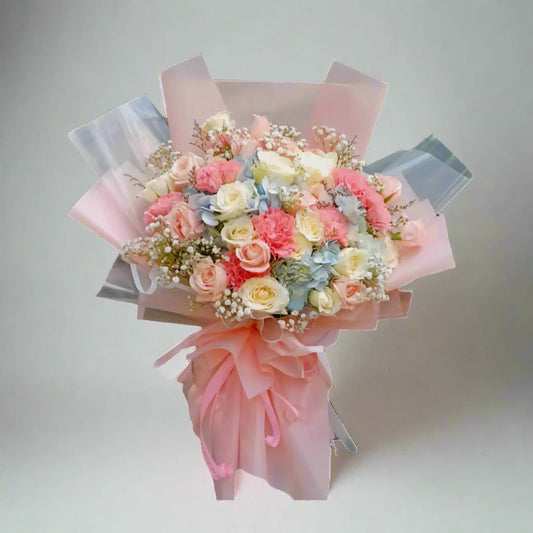 Bouquet of flowers wrapped in pink paper on a light gray background