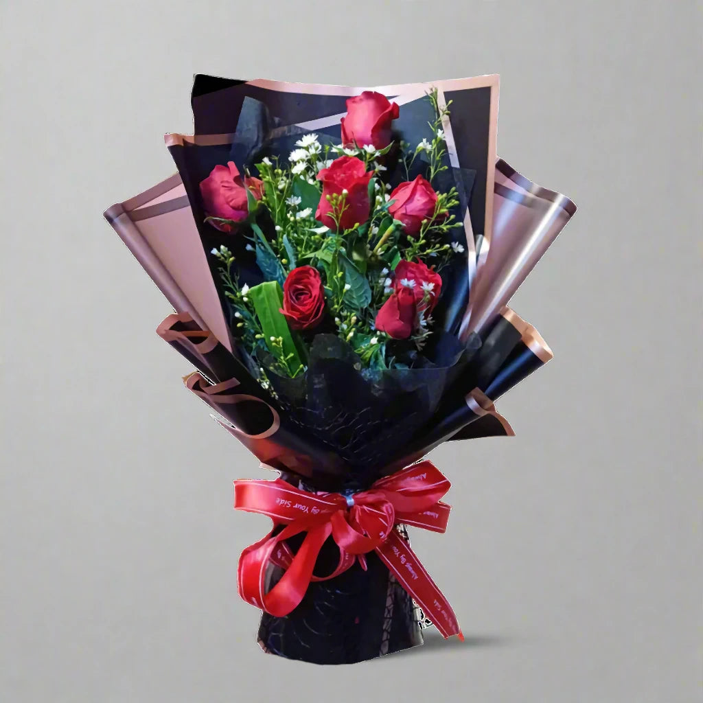 Bouquet of red roses with a red ribbon on a gray background