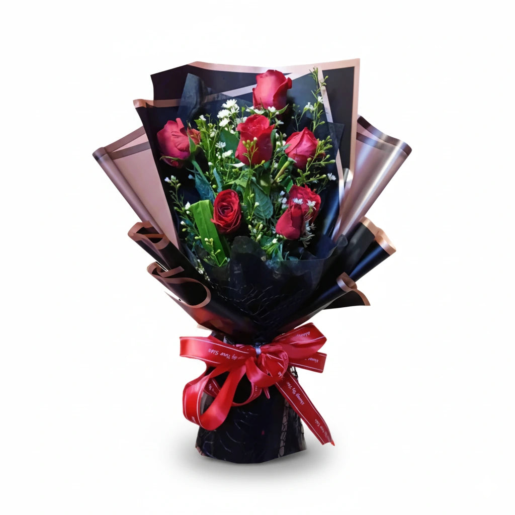 Bouquet of red roses wrapped in black paper with a red ribbon on a white background