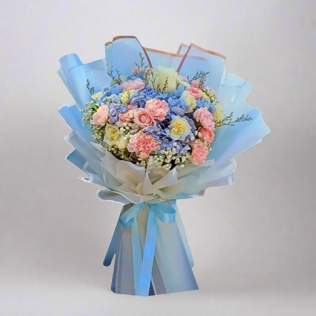 Bouquet of flowers wrapped in light blue paper on a white background