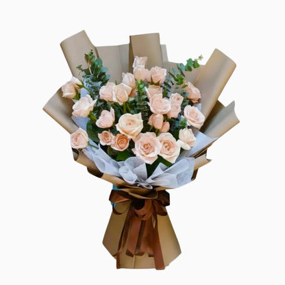 Bouquet of pink roses wrapped in brown paper with a brown ribbon on a light gray background