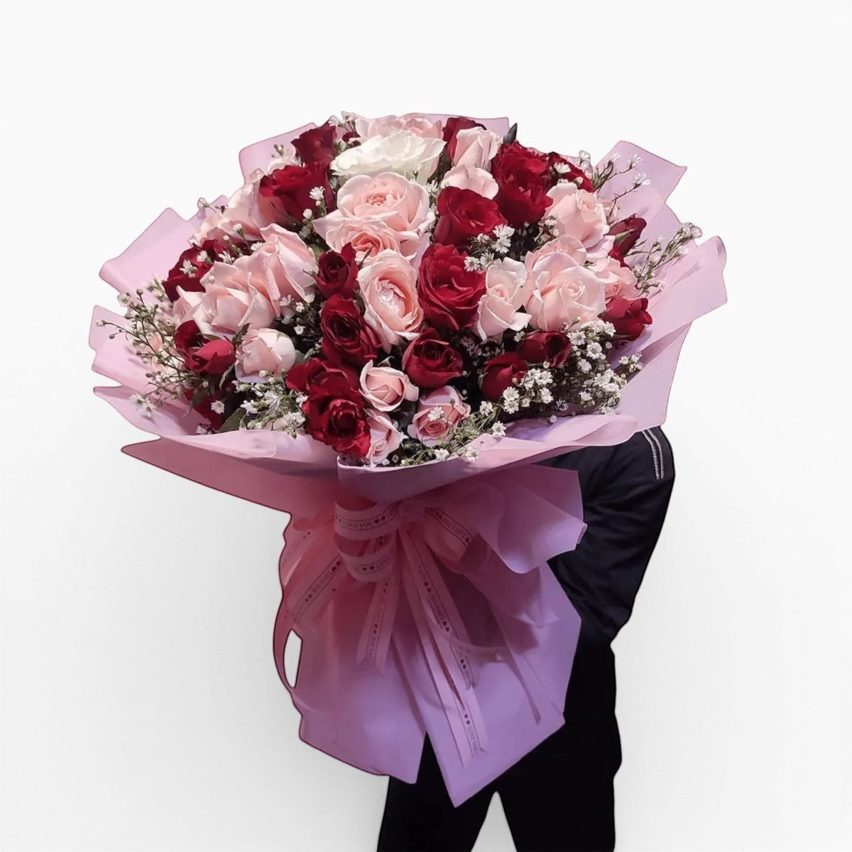 The Flowercart bouquet of 100 red and pink roses with baby's breath wrapped in pink paper for romantic occasions.