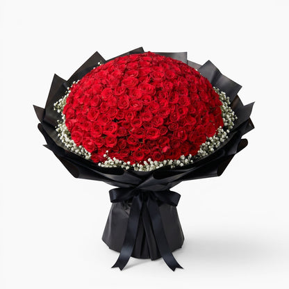 The Flowercart opulent bouquet of 199 red roses with baby's breath wrapped in dramatic black paper and a silk ribbon.