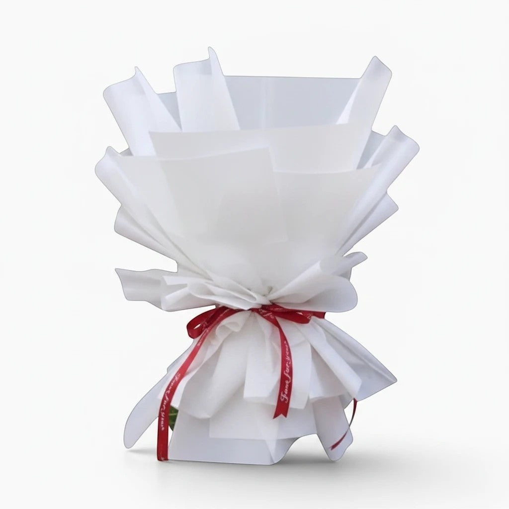The Flowercart 36 Stalk of Love bouquet featuring red roses wrapped in crisp white paper with a red ribbon.