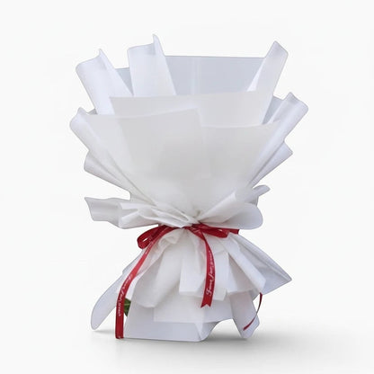 The Flowercart 36 Stalk of Love bouquet featuring red roses wrapped in crisp white paper with a red ribbon.
