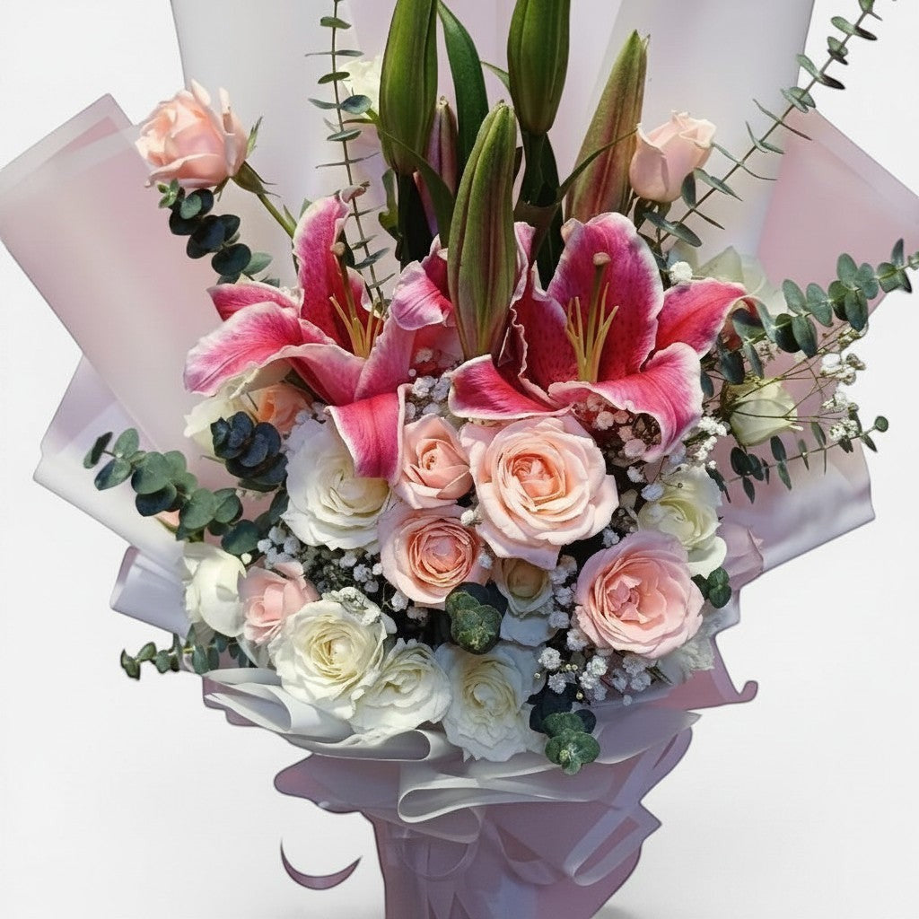 The Flowercart Caitlyn Bouquet featuring white and pink roses, stargazer lilies, and eucalyptus in pink wrapping.