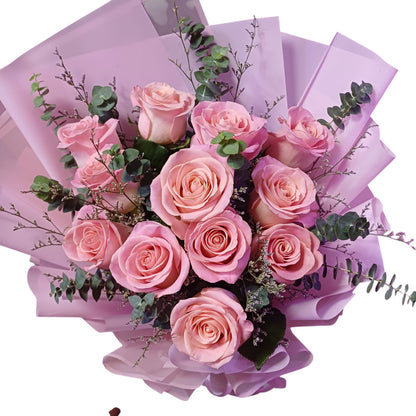 The Flowercart Château Bloom bouquet featuring twelve pink Ecuadorian roses with eucalyptus and misty fillers.
