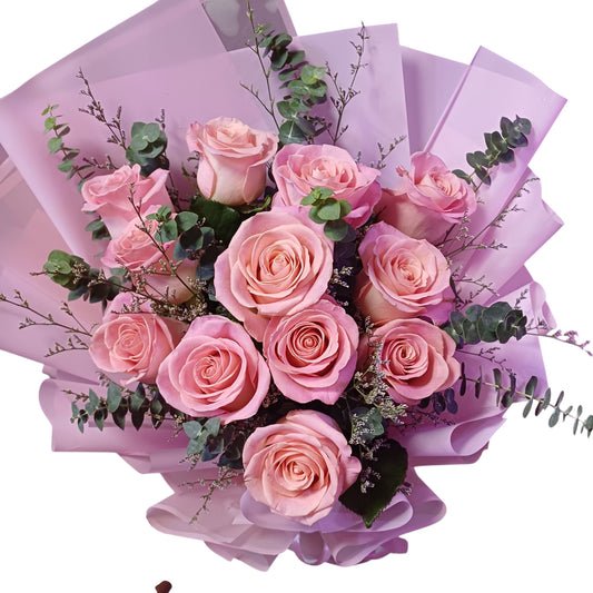 The Flowercart Château Bloom bouquet featuring twelve pink Ecuadorian roses with eucalyptus and misty fillers.