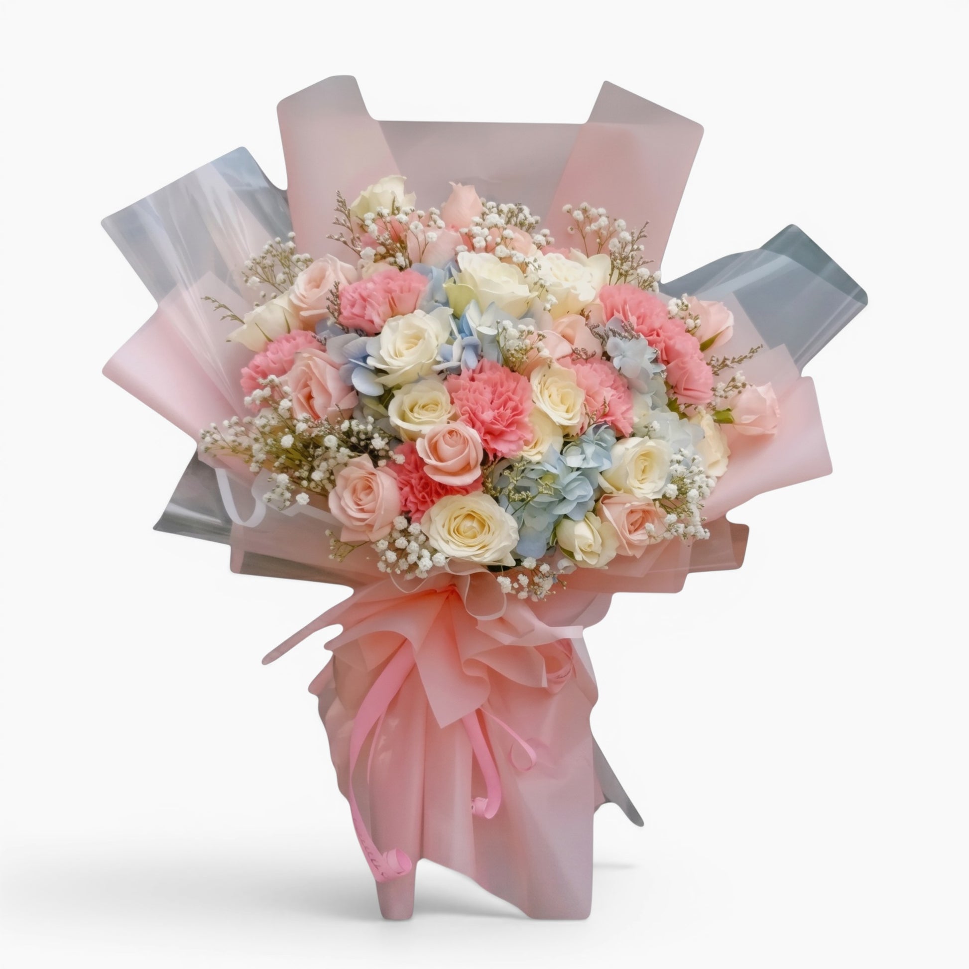 The Flowercart Pastel Dreams bouquet featuring pink and white roses, carnations, blue hydrangea, and baby's breath.