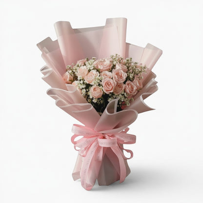 The Flowercart Dreaming of you bouquet with 24 pink roses and baby's breath wrapped in elegant soft pink paper