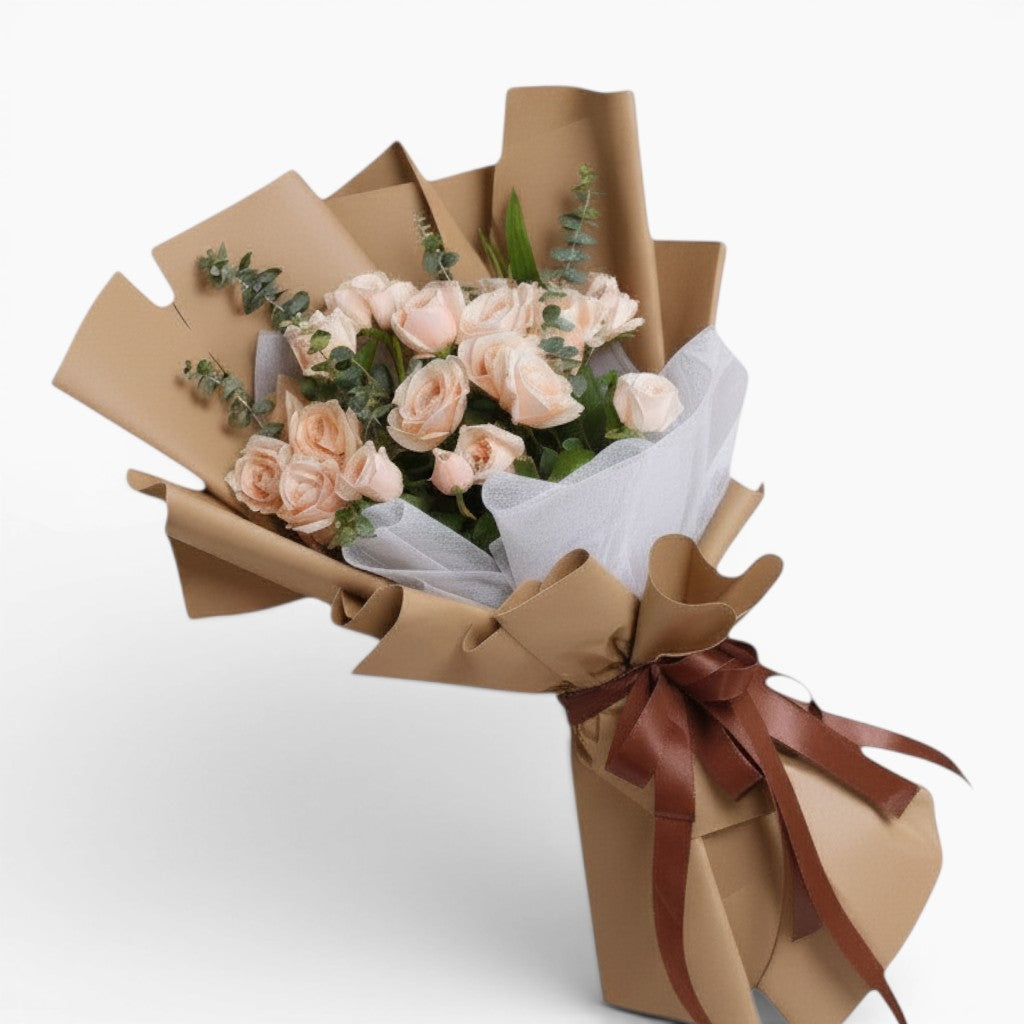 The Flowercart Terra Cotta bouquet featuring 24 soft pink roses and fresh eucalyptus wrapped in brown paper.