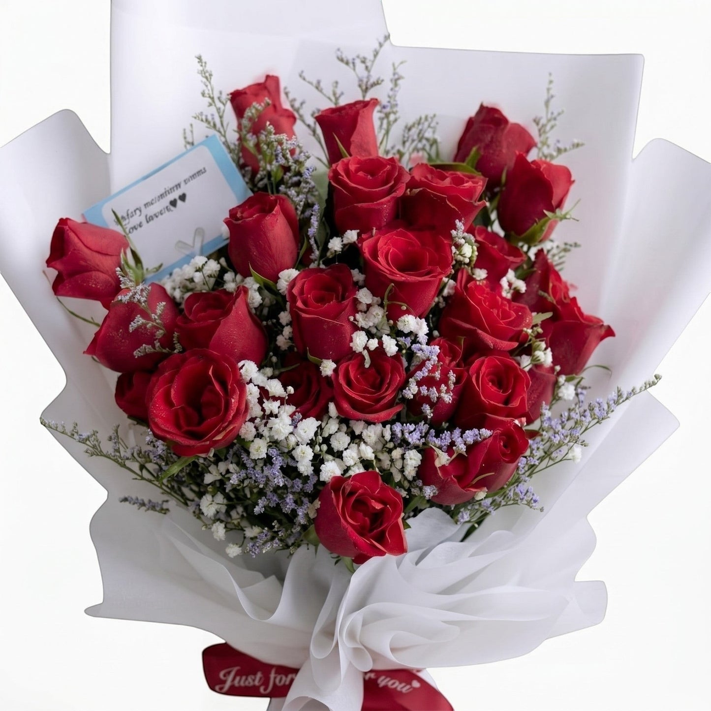 The Flowercart Fallin For You bouquet featuring 24 deep red roses with baby's breath and misty blue fillers.