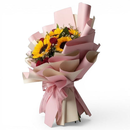 The Flowercart bouquet with yellow sunflowers and red roses wrapped in elegant pink paper for anniversaries.