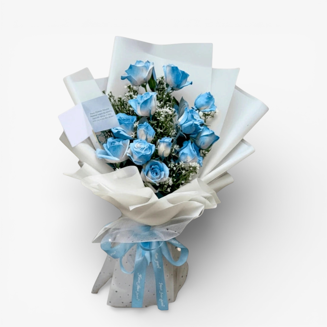 The Flowercart 12 blue roses bouquet with white wrapping and blue ribbon. Perfect for unique gifts.