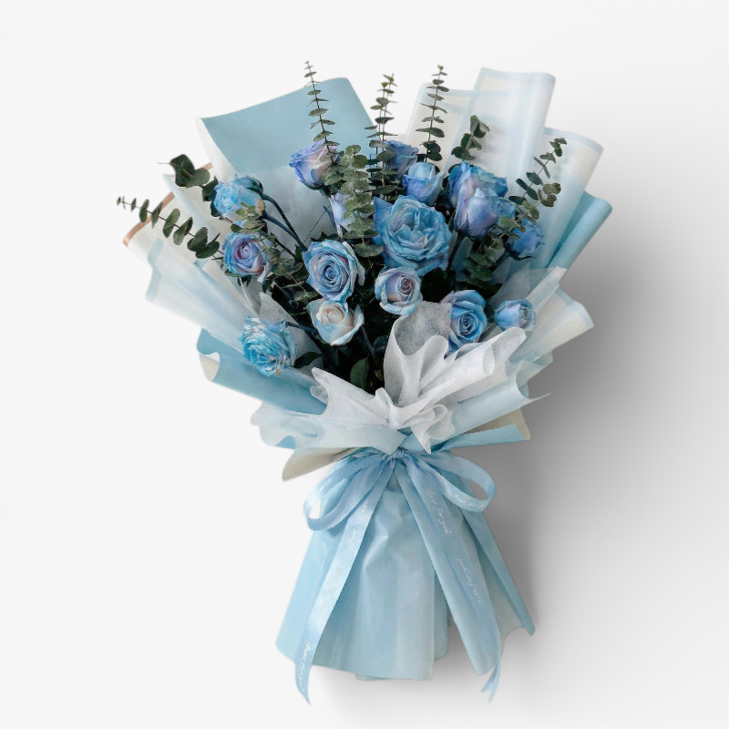 The Flowercart's unique bouquet of 24 blue spray roses and eucalyptus, wrapped in light blue and white paper with a blue ribbon.