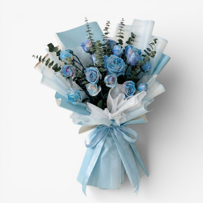 The Flowercart's unique bouquet of 24 blue spray roses and eucalyptus, wrapped in light blue and white paper with a blue ribbon.