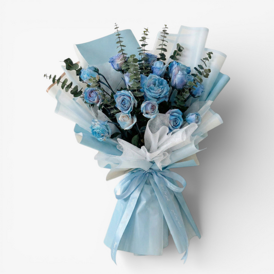 The Flowercart's unique bouquet of 24 blue spray roses and eucalyptus, wrapped in light blue and white paper with a blue ribbon.
