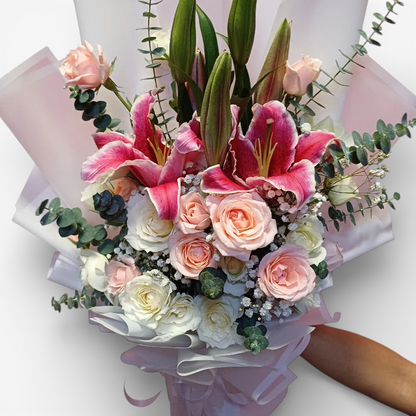 The Flowercart Caitlyn bouquet: 24 white & pink roses, Stargazer lilies, eucalyptus, gypsophila. Elegant floral arrangement.
