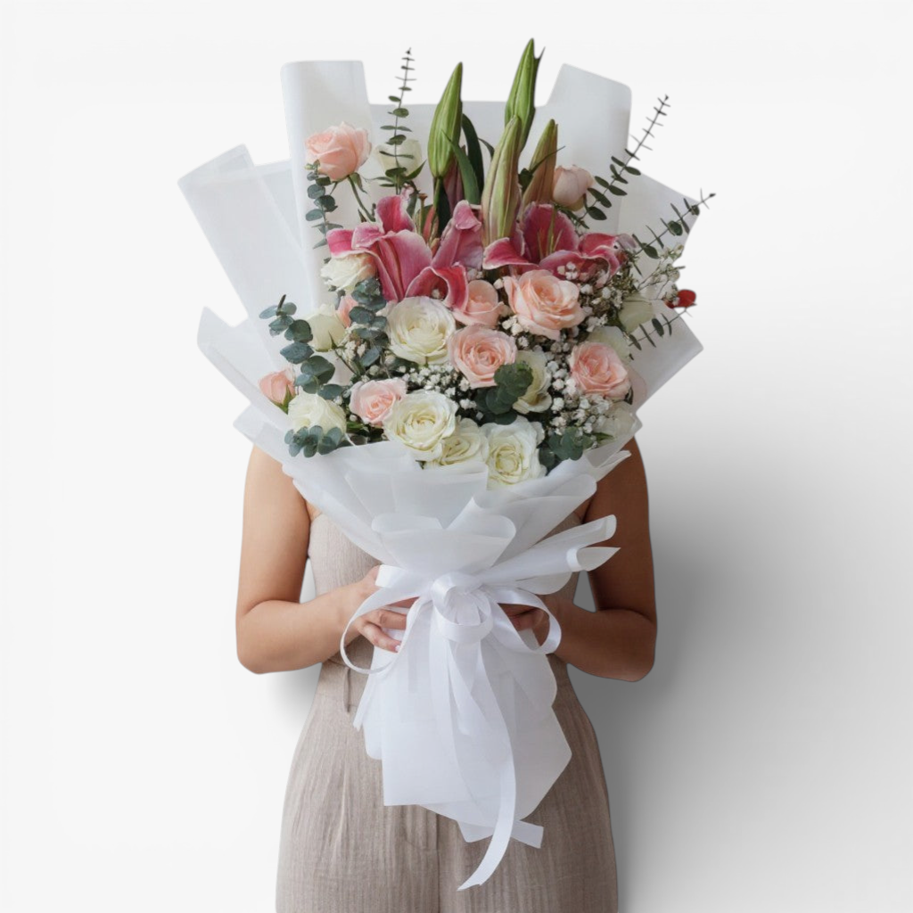The Flowercart Caitlyn bouquet: 24 white & pink roses, Stargazer lilies, eucalyptus, gypsophila. Elegant floral arrangement.