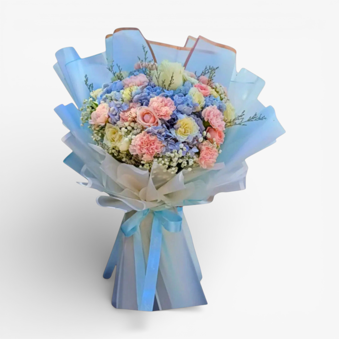 The Flowercart Pastel Blossom bouquet: pink carnations, pink & white roses, blue hydrangea, baby's breath. 60cm H x 40cm L.