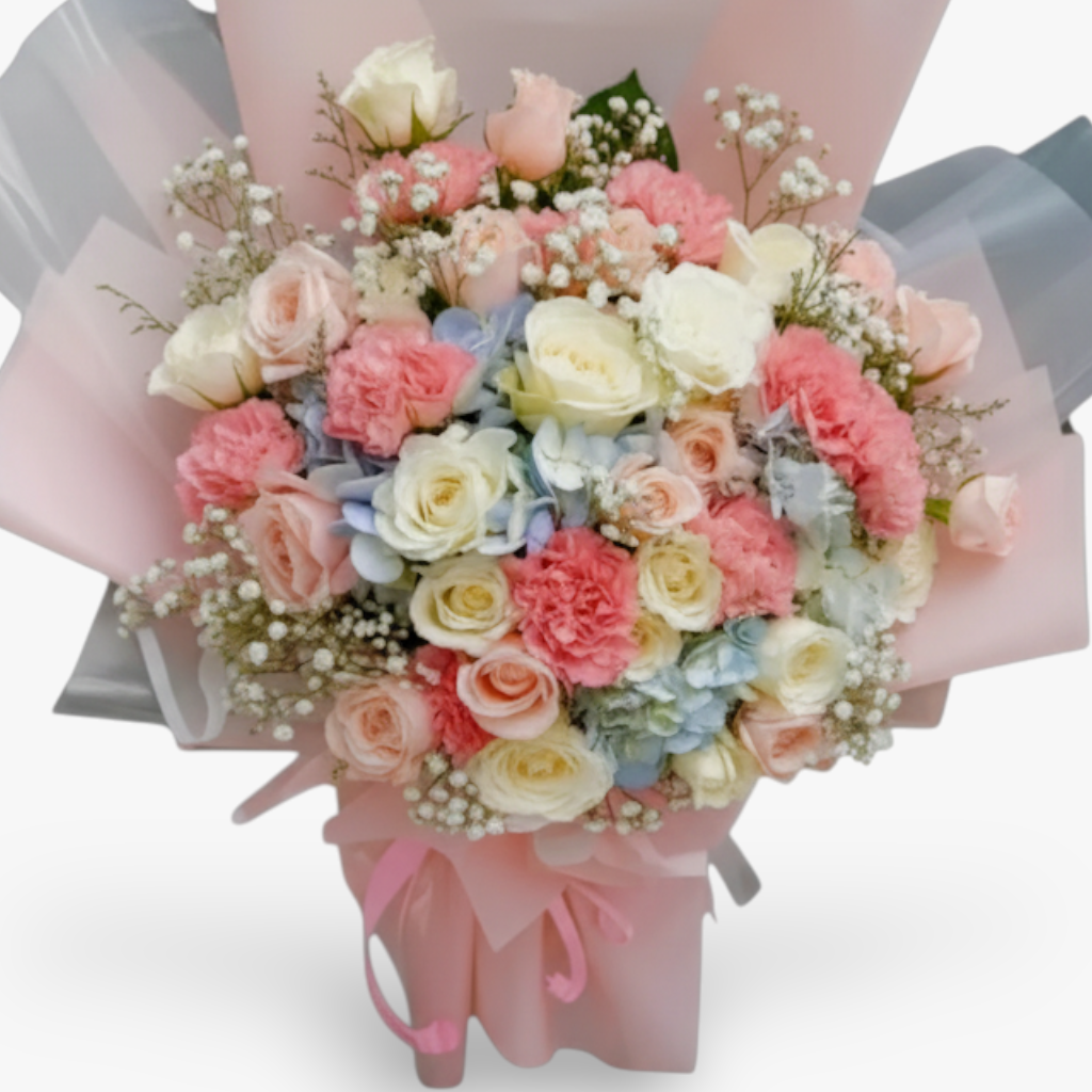 The Flowercart Pastel Dreams bouquet: pink roses, white roses, pink carnations, blue hydrangea, and baby's breath.