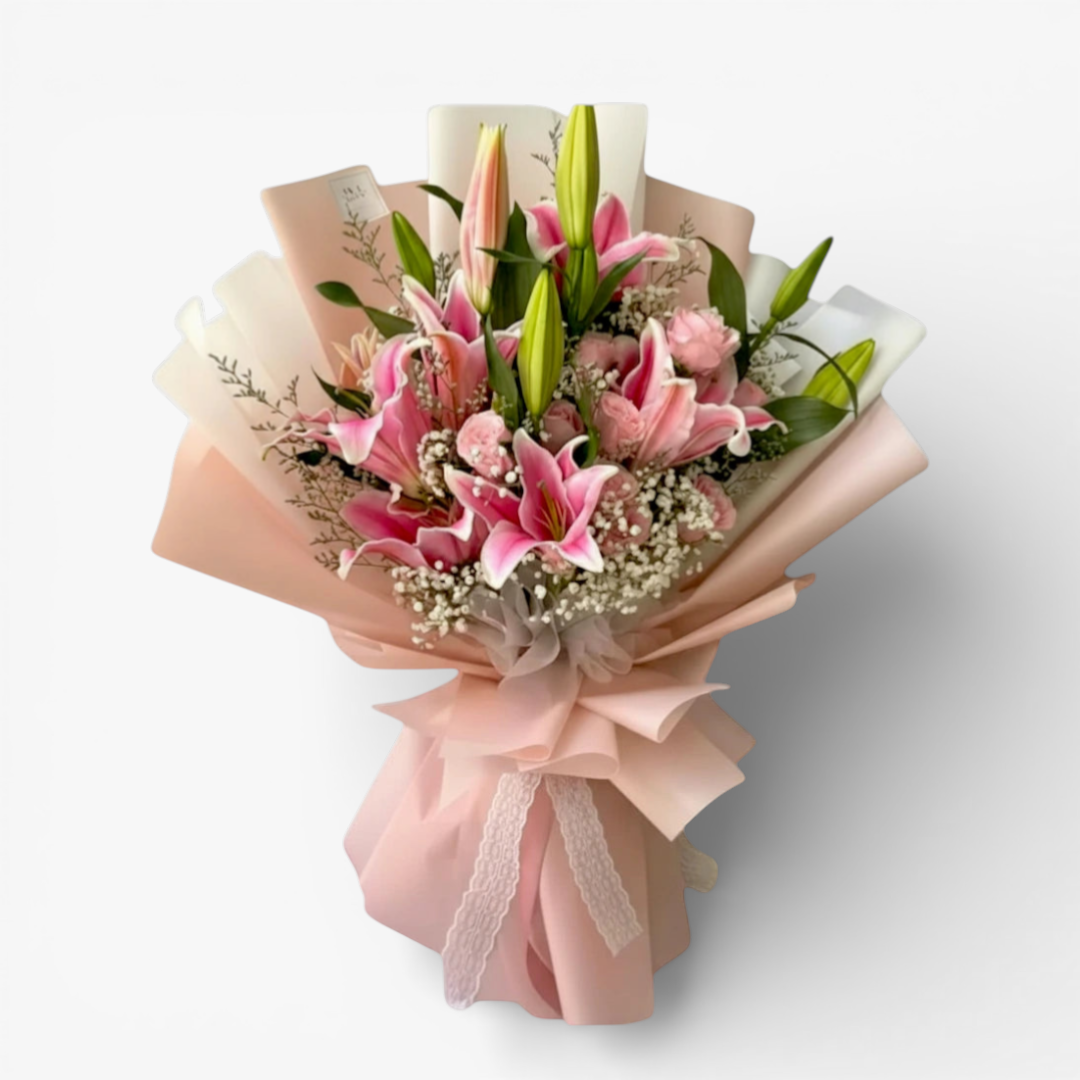 The Flowercart Star Lily bouquet features pink Stargazer lilies, pink roses, baby's breath, and misty blue fillers, elegantly wrapped.