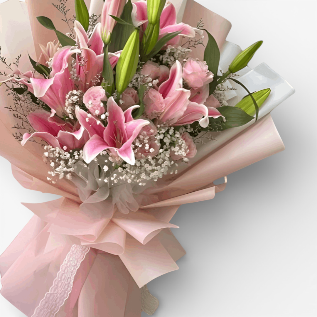 The Flowercart Star Lily bouquet features pink Stargazer lilies, pink roses, baby's breath, and misty blue fillers.
