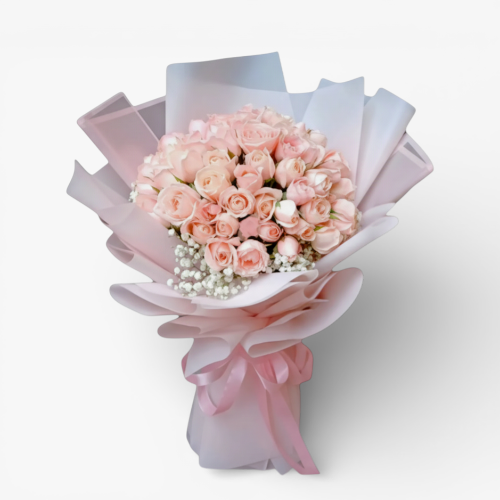 The Flowercart Mardigrass bouquet with 50 premium pink roses and baby's breath, wrapped in pink and white paper with a pink ribbon.