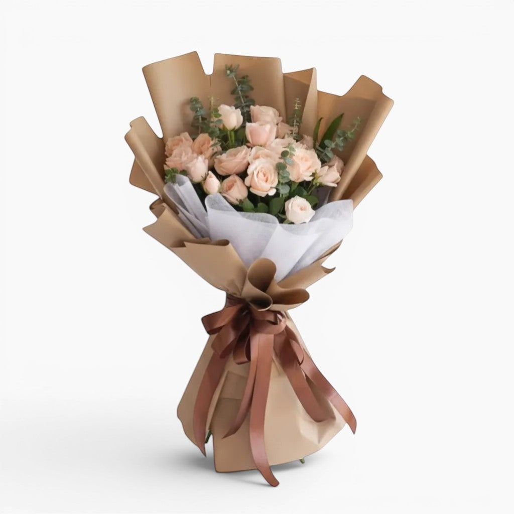 The Flowercart Terra Cotta bouquet: 24 soft pink roses and eucalyptus, wrapped in brown paper with a satin ribbon.