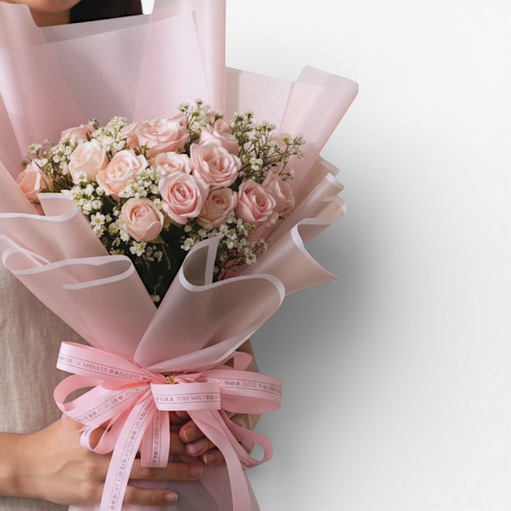 The Flowercart's California Dreaming bouquet: 24 soft pink roses with baby's breath, wrapped in pink paper with a pink ribbon.