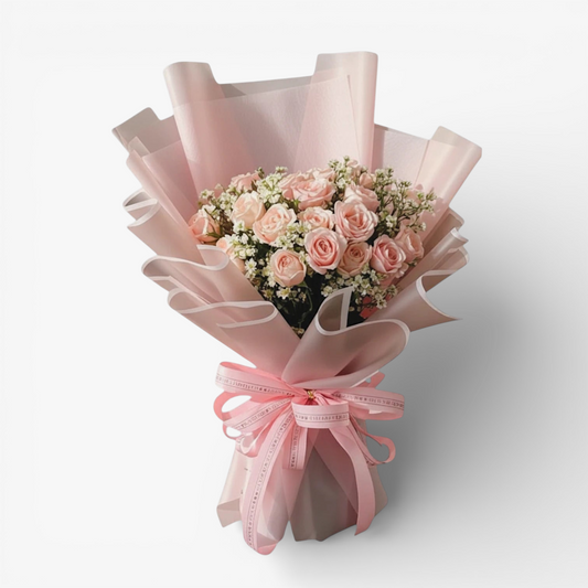 The Flowercart's California Dreaming bouquet: 24 soft pink roses with baby's breath, wrapped in pink paper and tied with a pink ribbon.