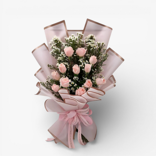 The Flowercart bouquet of 12 pink roses with white fillers, wrapped in pink paper and tied with a pink ribbon.