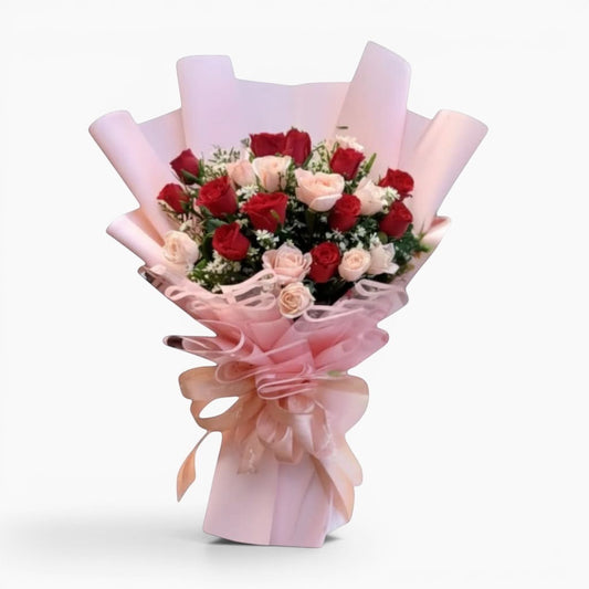 The Flowercart's Majestic Bouquet: 24 red and pink roses with baby's breath and greenery, wrapped in pink paper with a gold accent and ribbon.