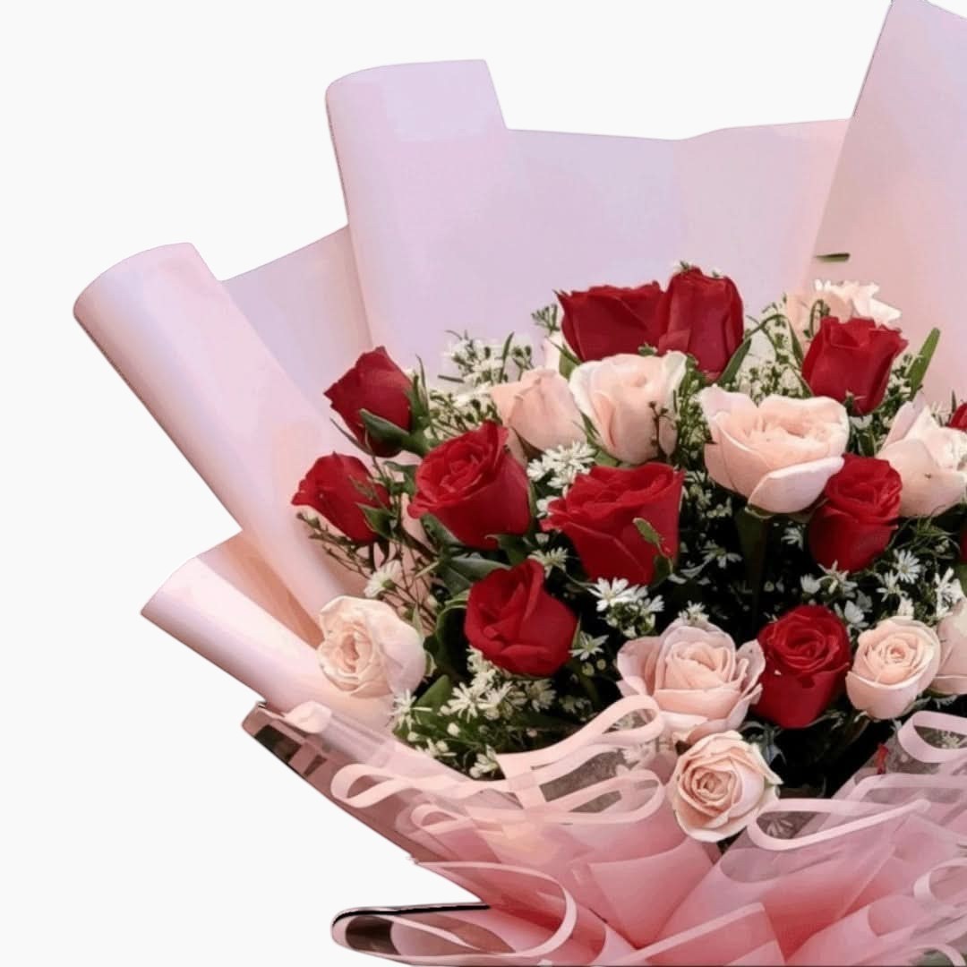 The Flowercart Majestic Bouquet: 24 red and pink roses with baby's breath and greenery, perfect for anniversaries.